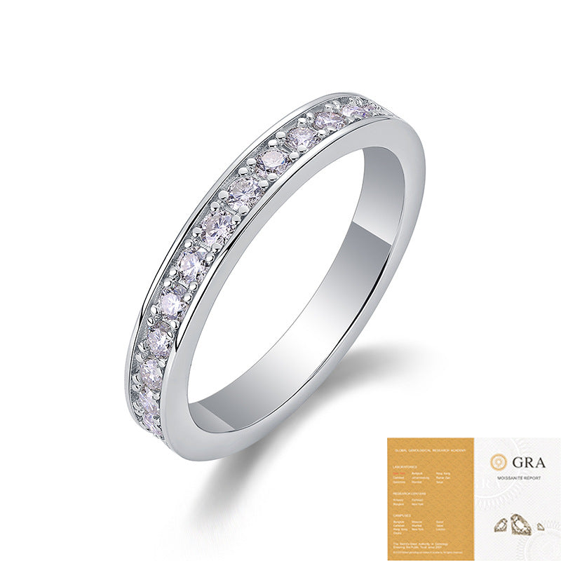 Silver ring with pink gemstones and a GRA certification card on a white background