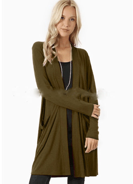 Woman wearing a long olive green cardigan on a white background