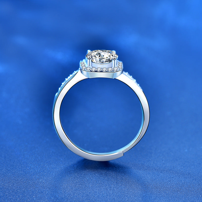 Silver ring with a diamond on a blue background