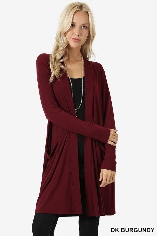 Woman wearing a burgundy cardigan on a white background