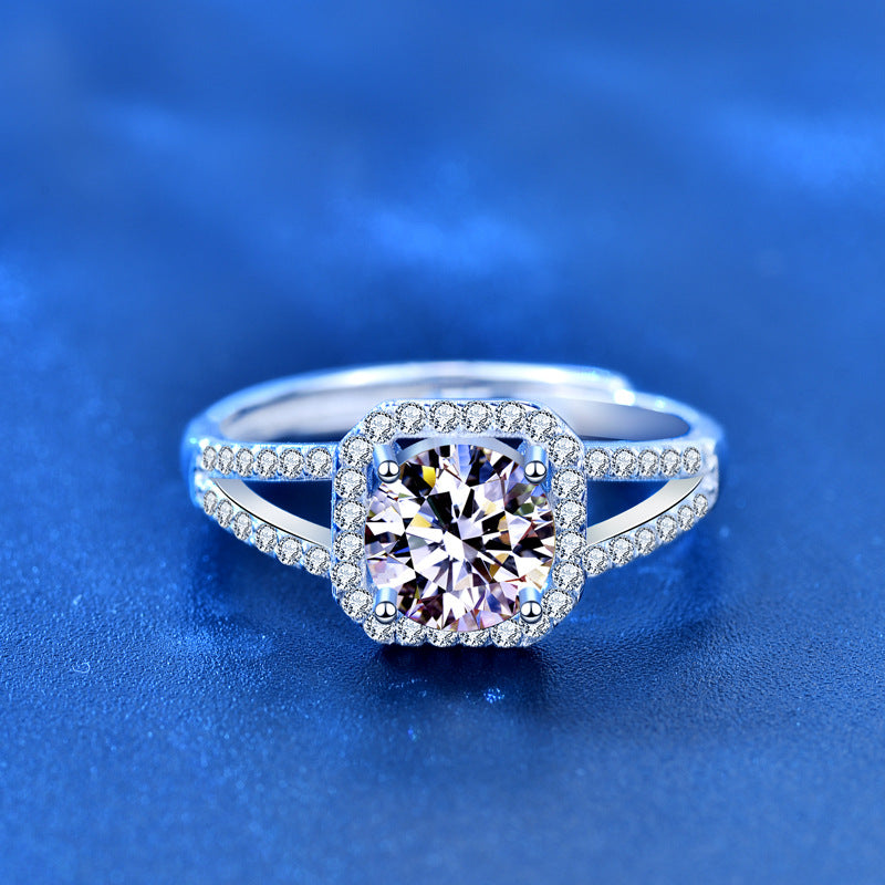 Silver ring with a large diamond on a blue background